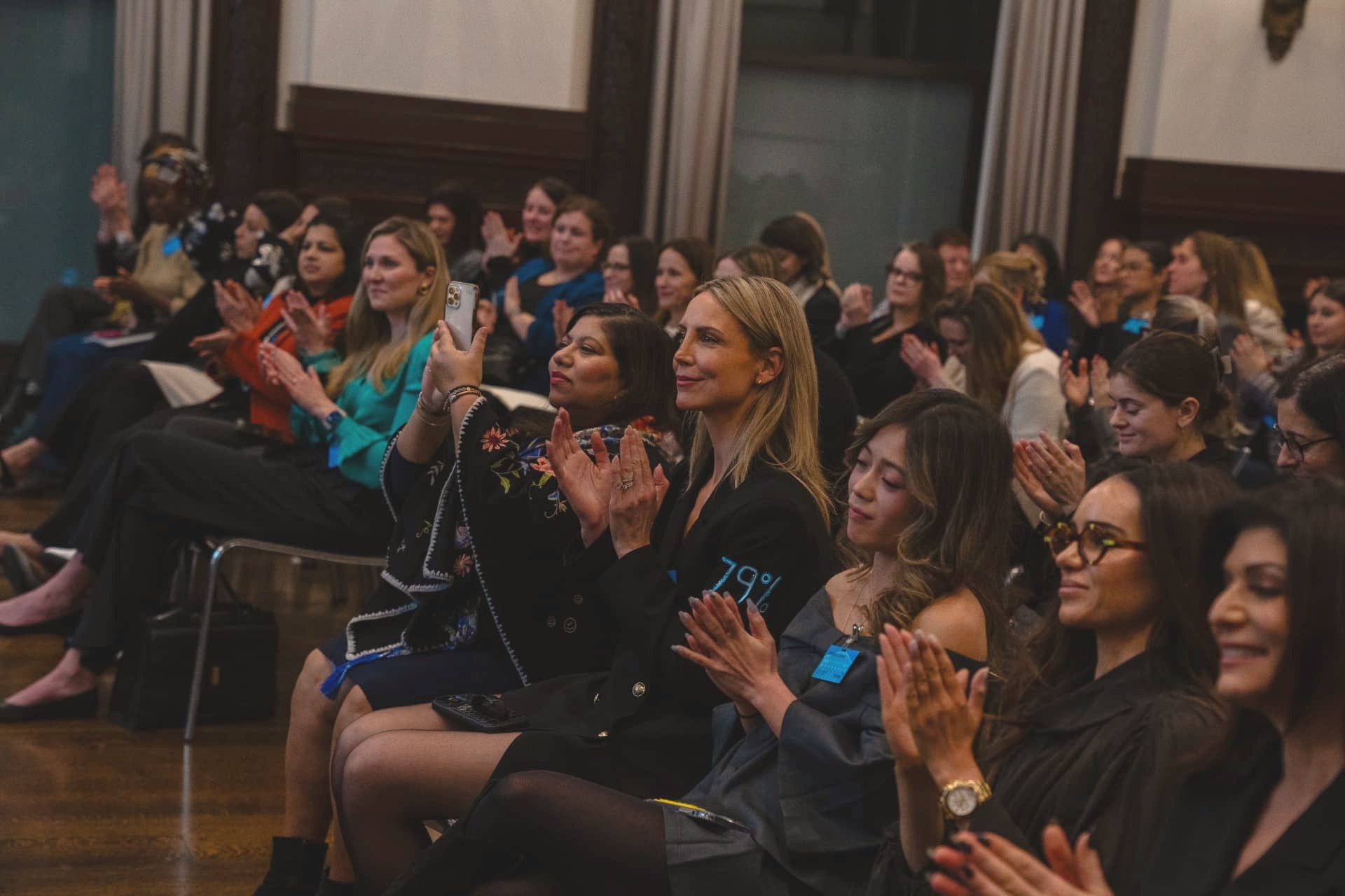 Attendees applauding at a Women’s Health PAC convening